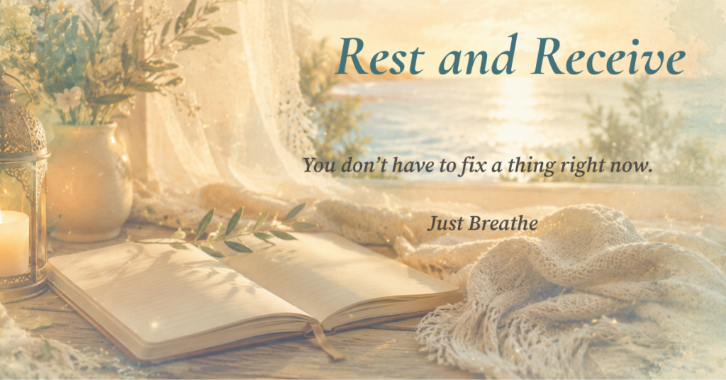 open journal beside a candle and soft blanket overlooking the ocean